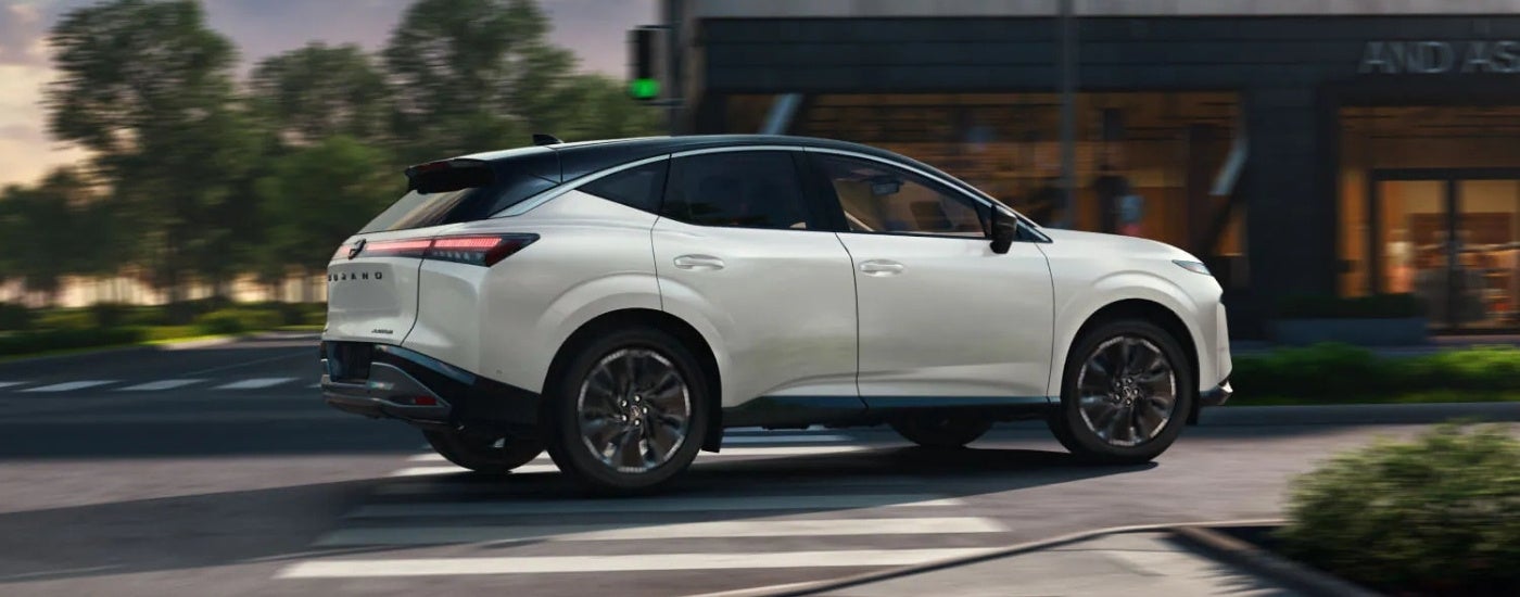 A white 2026 Nissan Murano from the side after leaving a Nissan dealer.