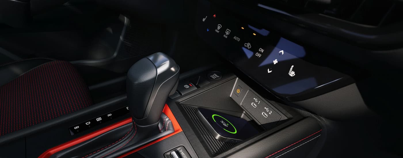 Phone charging in the center console of a 2026 Nissan Kicks