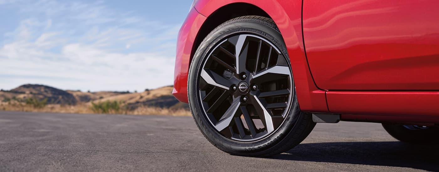 Tire and rim on a red 2026 Nissan Versa