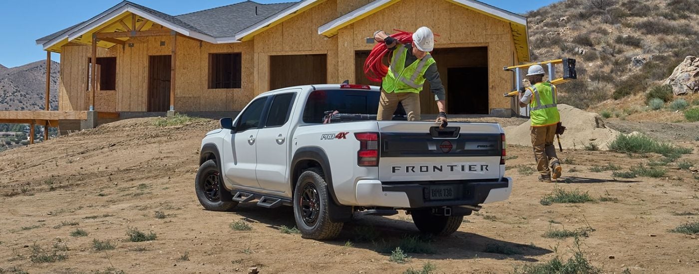 White 2026 Nissan Frontier on a construction site.