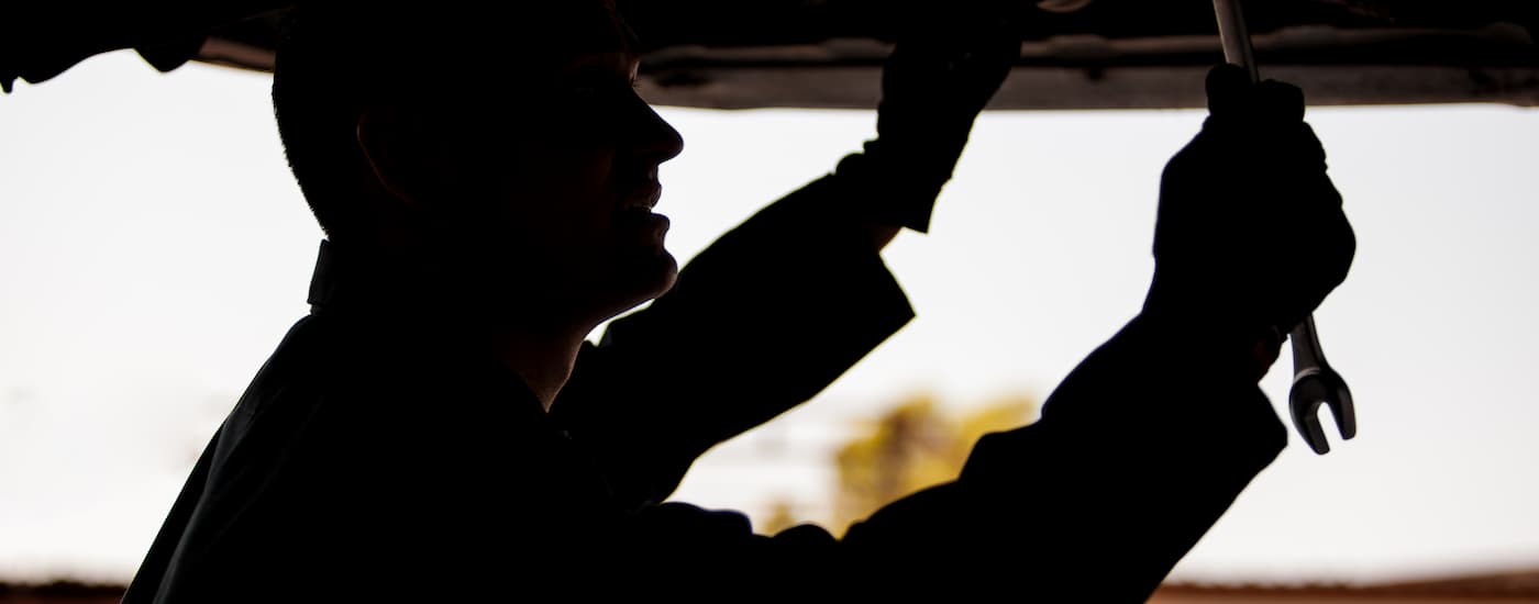 Mechanic working underneath a vehicle on a lift